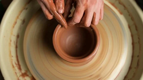 Top view of the potter's work. Hands masterfully work a clay pot Stock Footage 160714351