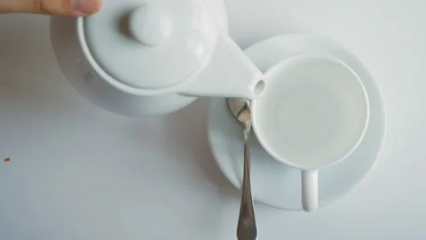 Top view of pouring fruit tea into a white porcelain teapot.Tea time Stock Footage 111614144
