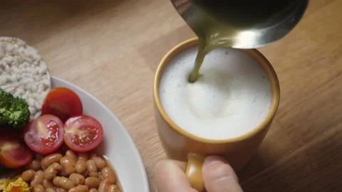 Top view of pouring matcha tea into foamed plant based milk. Healthy vegan Stock Footage 139841071