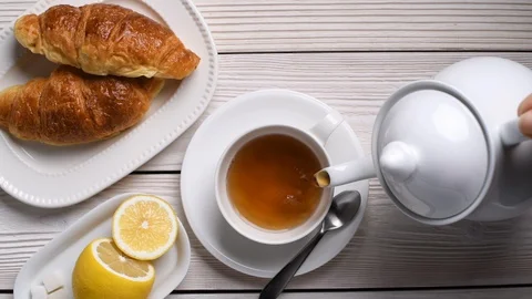 Top view of pouring tea on a cup Stock Footage 129814270