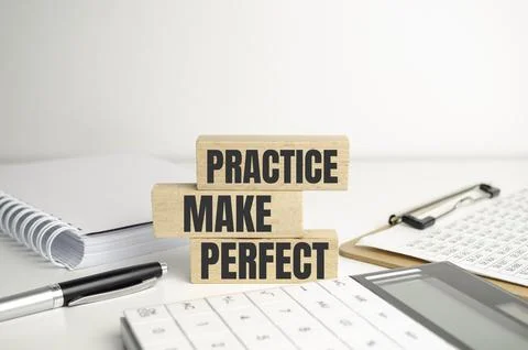 Top view of Practice Makes Perfect words on wooden cube Stock Photos