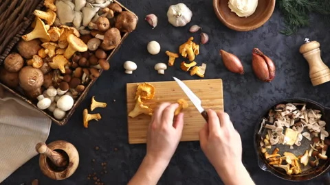 Top view of preparation and frying of edible wild mushrooms. Stock Footage 100772878