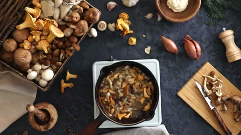 Top view of preparation and frying of edible wild mushrooms. Stock Footage 100772946