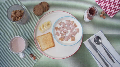 Top view preparation breakfast women's hand stirred with a spoon cereal with Stock Footage 138078409