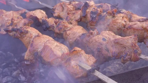 Top View of Preparing Shish Kebabs on Skewers over a Fire in Nature. Cooking Stock Footage 104424204