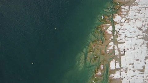 Top view of previously underwater rocks in Sirmione along Garda Lake, Italy Stock Footage 220307078