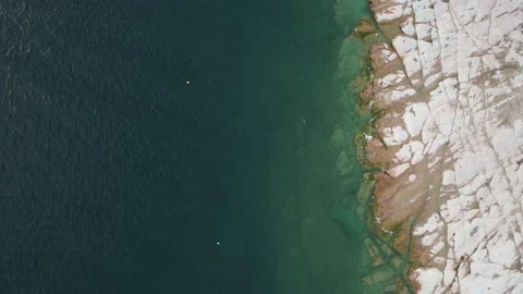 Top view of previously underwater rocks in Sirmione along Garda Lake, Italy Stock Footage 220307433