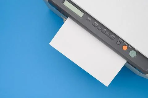 Top view of printer and blank a4 paper on blue background.Multifunction printer. Stock Photos