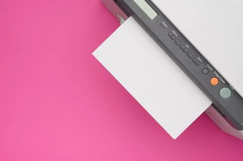 Top view of the printer and a blank sheet of a4 paper on a pink background Stock Photos