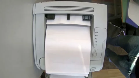 Top view of a printer printing a4 piece of paper documents Stock Footage 235252877