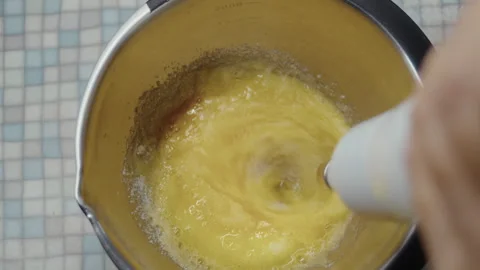 Top view, the process of beating eggs with sugar with a hand mixer Stock Footage 337122232