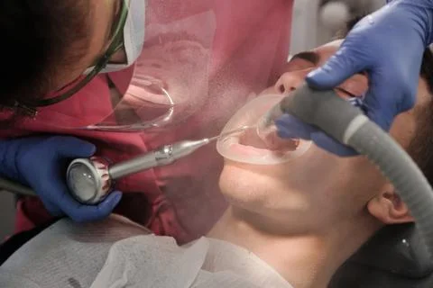Top view of the process of brushing the patient's teeth. Brushing teeth with Stock Photos