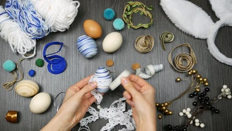 Top view process of making easter egg. Woman pick decor for stylish eggs Video stock 104930435