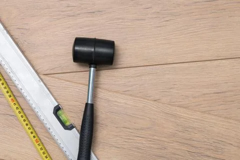 Top view of professional carpentry tools on laminate or parquet boards. Minim Stock Photos