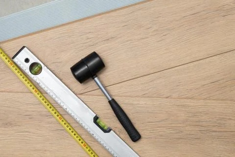 Top view of professional carpentry tools on laminate or parquet boards. Minim Stock Photos