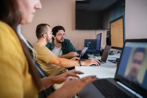 Top view of programmer diligently testing smartphone applications while sitting Stock Photos