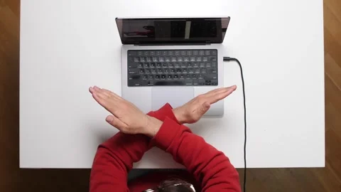 Top view Programmer making stop sign with hands at office desk Stock-Footage 311202141