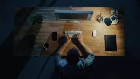 Top View of a Programmer Writing Code on His Personal Computer at Night. Stock Photos