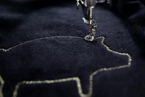 Top view on progress of pig motive made by embroidery machine with gold yarn Stock Photos