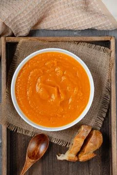 Top View of Pumpkin Soup with Bread on Wooden Tray Stock Photos