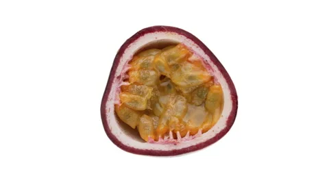 Top view of purple passion fruit cross cut rotating on white background. Stock Footage 159153151