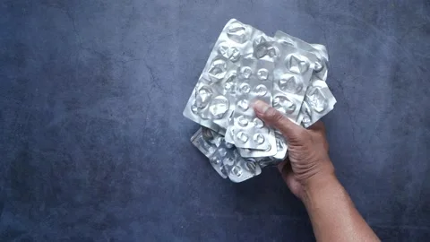 Top view of putting empty pills of blister pack on table Stock Footage 226979373