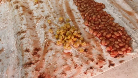 Top view putting rows of baked beans and sweet corn on pita bread covered with Stock Footage 266827522
