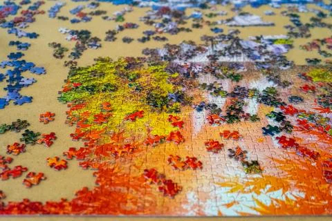 Top view of a puzzle in the process of being built with its colorful pieces.. Stock Photos