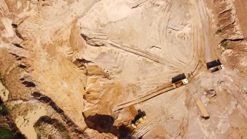 Top view from quadcopter to wheel loader and dump trucks in quarry Stock Footage 163375038
