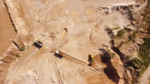 Top view from quadcopter to wheel loader and dump trucks in quarry Stock Footage 163375284