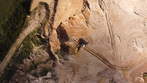 Top view from quadcopter to wheel loader and dump truck in quarry Stock Footage 163375753