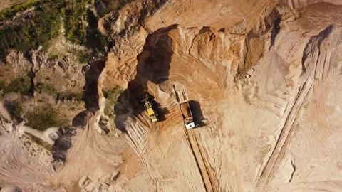Top view from quadcopter to wheel loader and dump truck in quarry Stock Footage 163375952