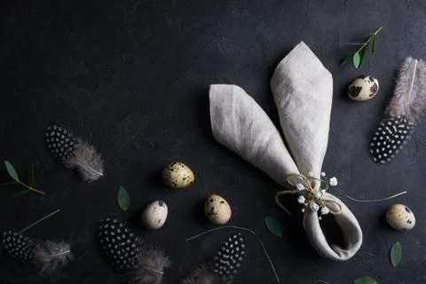 Top view of quail eggs, feather and bunny ears linen  napkin Stock Photos