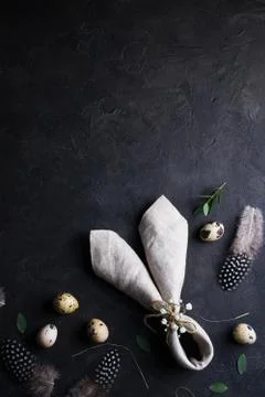 Top view of quail eggs, feather and bunny ears linen  napkin Stock Photos