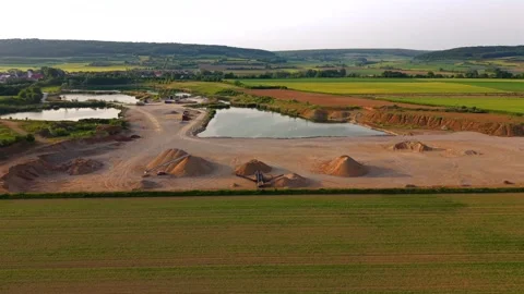 Top view of a quarry landscape featuring gravel stockpiles, extraction pits and Stock-Footage 336100581