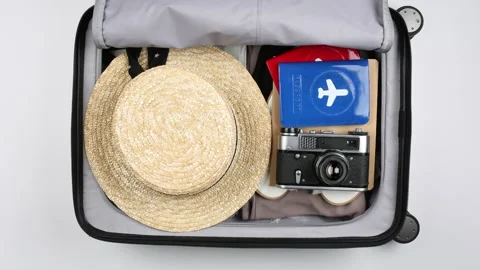 Top view quickly packing suitcase girls. Time lapse stop-motion Stock Footage 170891721