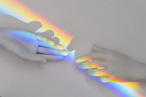 Top view of the rainbow prism reflection inside of the plastic hands Stock Photos