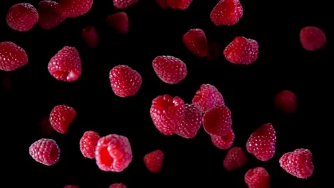 Top view raspberries bouncing with splashes of water on the black background Stock Footage 259513655