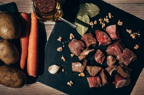 Top view of raw beef cut in a black slate plate Stock Photos