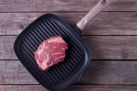 Top view of raw beef steak on grill pan. Receipt concept Stock Photos