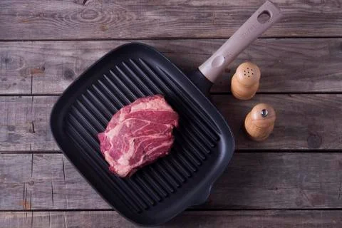 Top view of raw beef steak on grill pan. Receipt concept Stock Photos