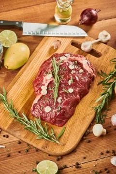 Top view on a raw beef steak on wooden cutting board Stock Photos