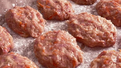 Top view of raw chicken and vegetable cutlets on a baking tray Vídeo Stock 304800052