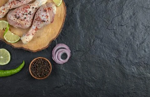 Top view. raw chicken legs with onion and pepper Stock Photos