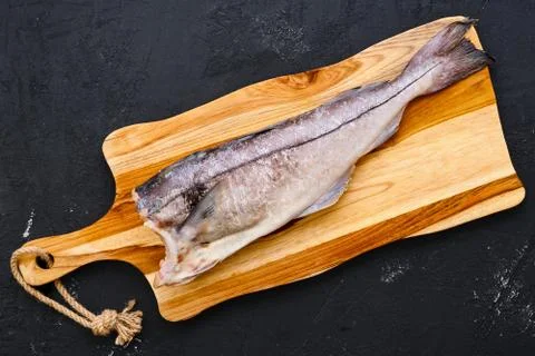Top view of raw fresh haddock carcass on wooden cutting board Stock-Fotos