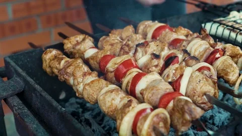 Top view of raw marinated meat skewers cooking on charcoal grill Stock Footage 343385332