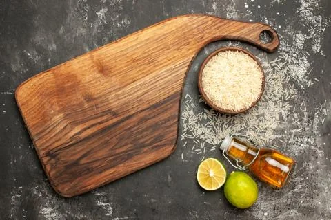 Top view raw rice with lemons and oil on dark background raw food fruit color Stock Photos