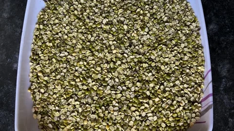 Top view of raw split green gram on a white square plate 스톡 동영상 328441268