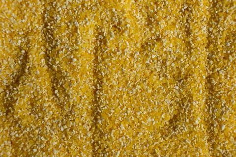 Top view of raw uncooked corn grits, textured cooking background Stock Photos