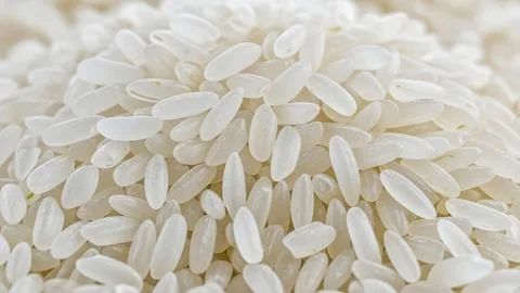Top view of raw white rice grains scattered on a flat surface for a healthy.. Foto stock